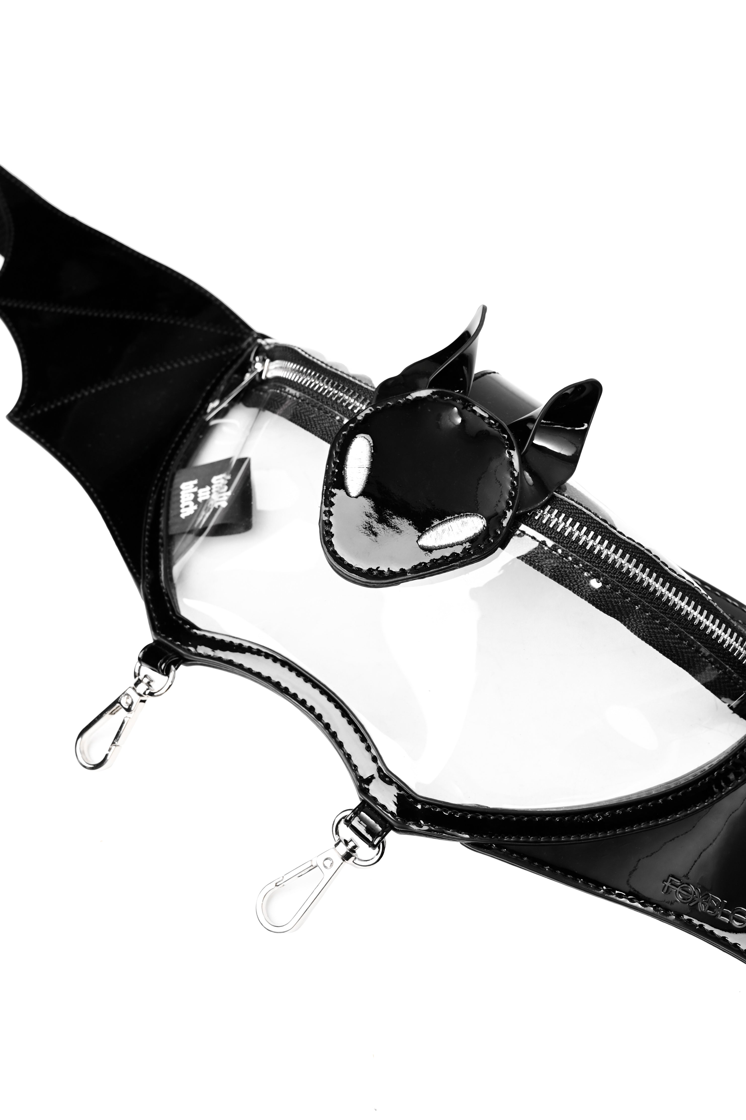 clear pvc fannypack in the shape of a bat with black patent pvc details, silver hardware, and 2 silver clasps on the bottom