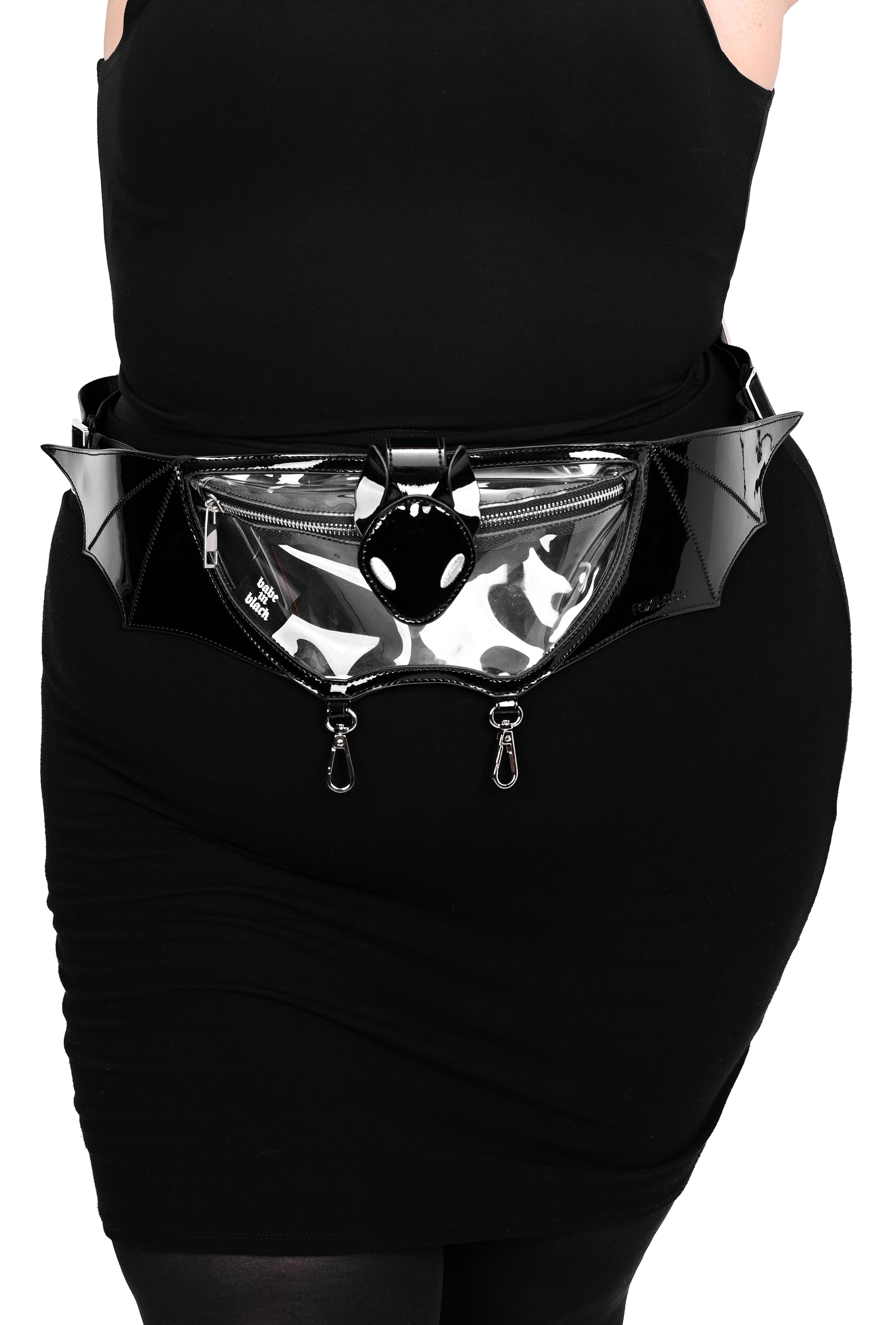 clear pvc fannypack in the shape of a bat with black patent pvc details, silver hardware, and 2 silver clasps on the bottom