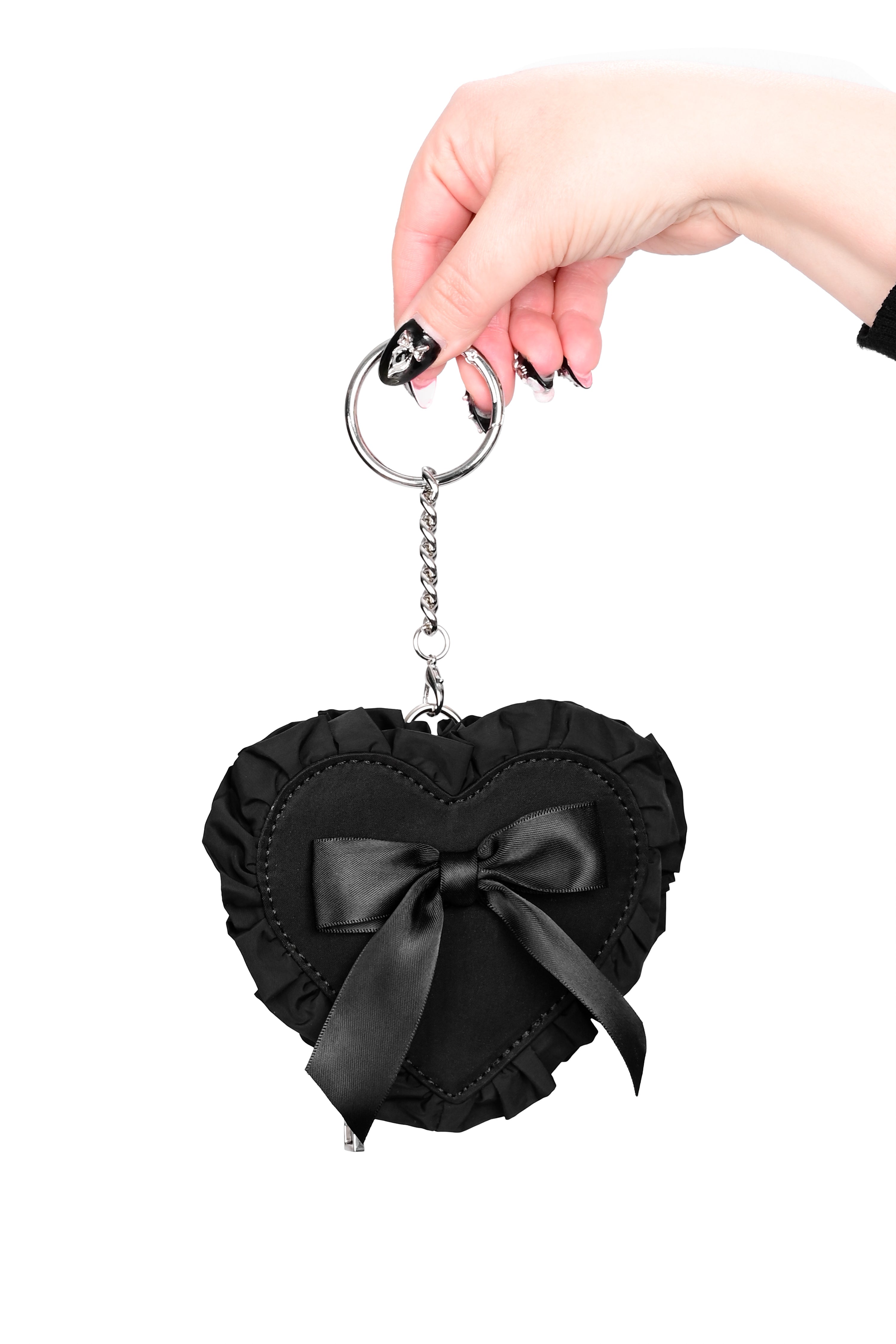 black nylon heart shaped coin purse with a ruffle edge and ribbon bow on front, and a silver chain attached to a self-closing clasp