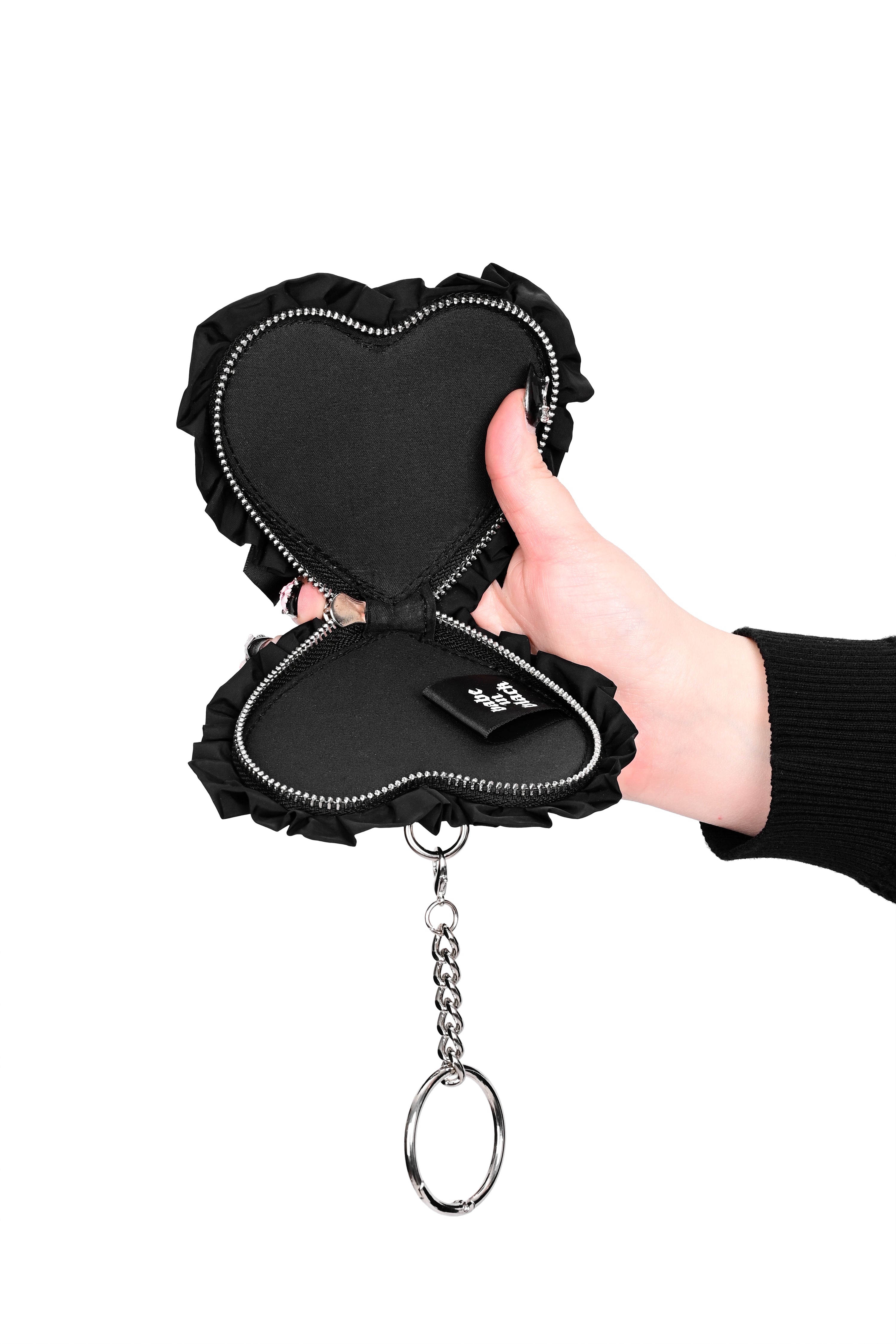 black nylon heart shaped coin purse with a ruffle edge and ribbon bow on front, and a silver chain attached to a self-closing clasp