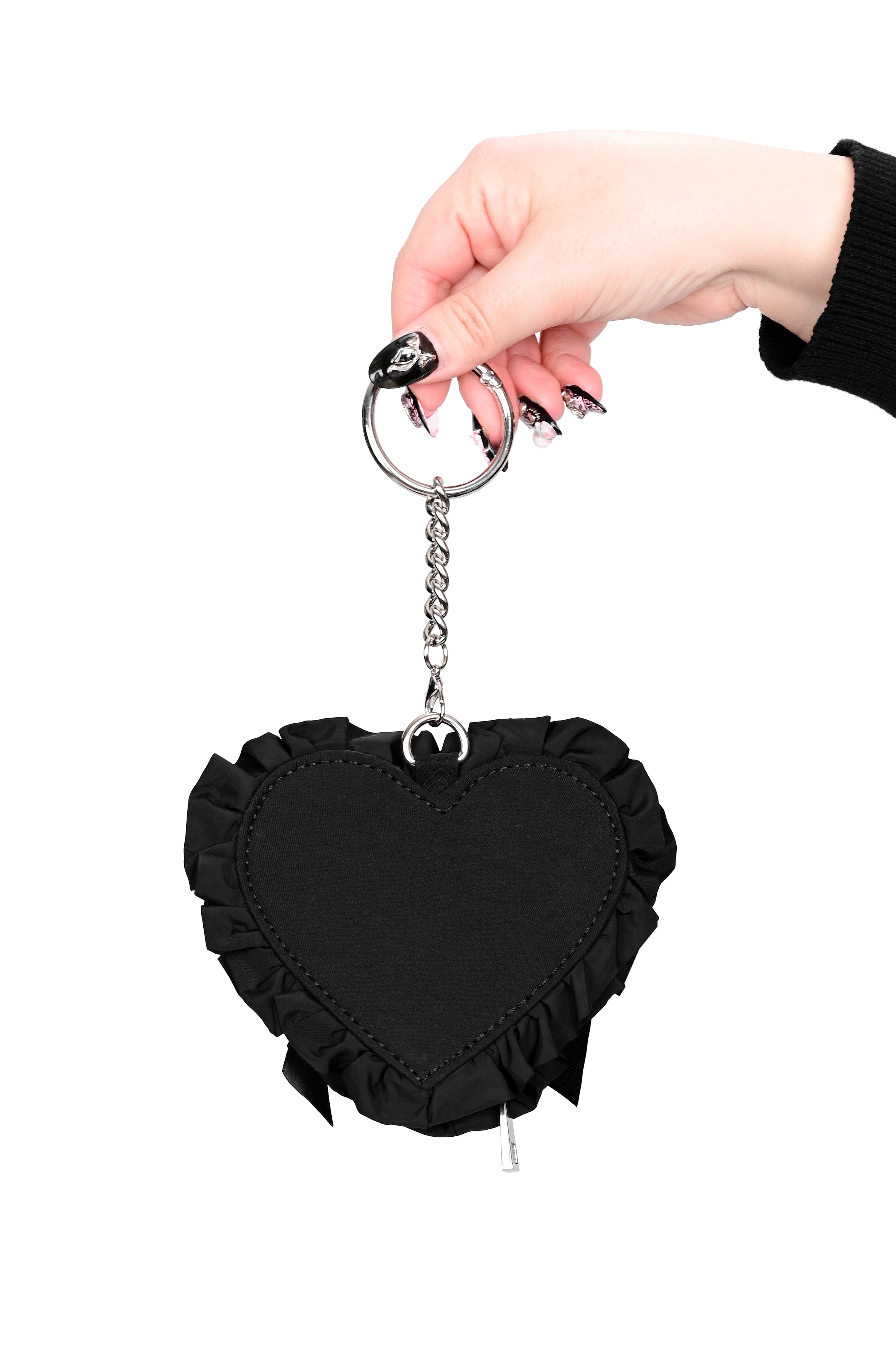 black nylon heart shaped coin purse with a ruffle edge and ribbon bow on front, and a silver chain attached to a self-closing clasp