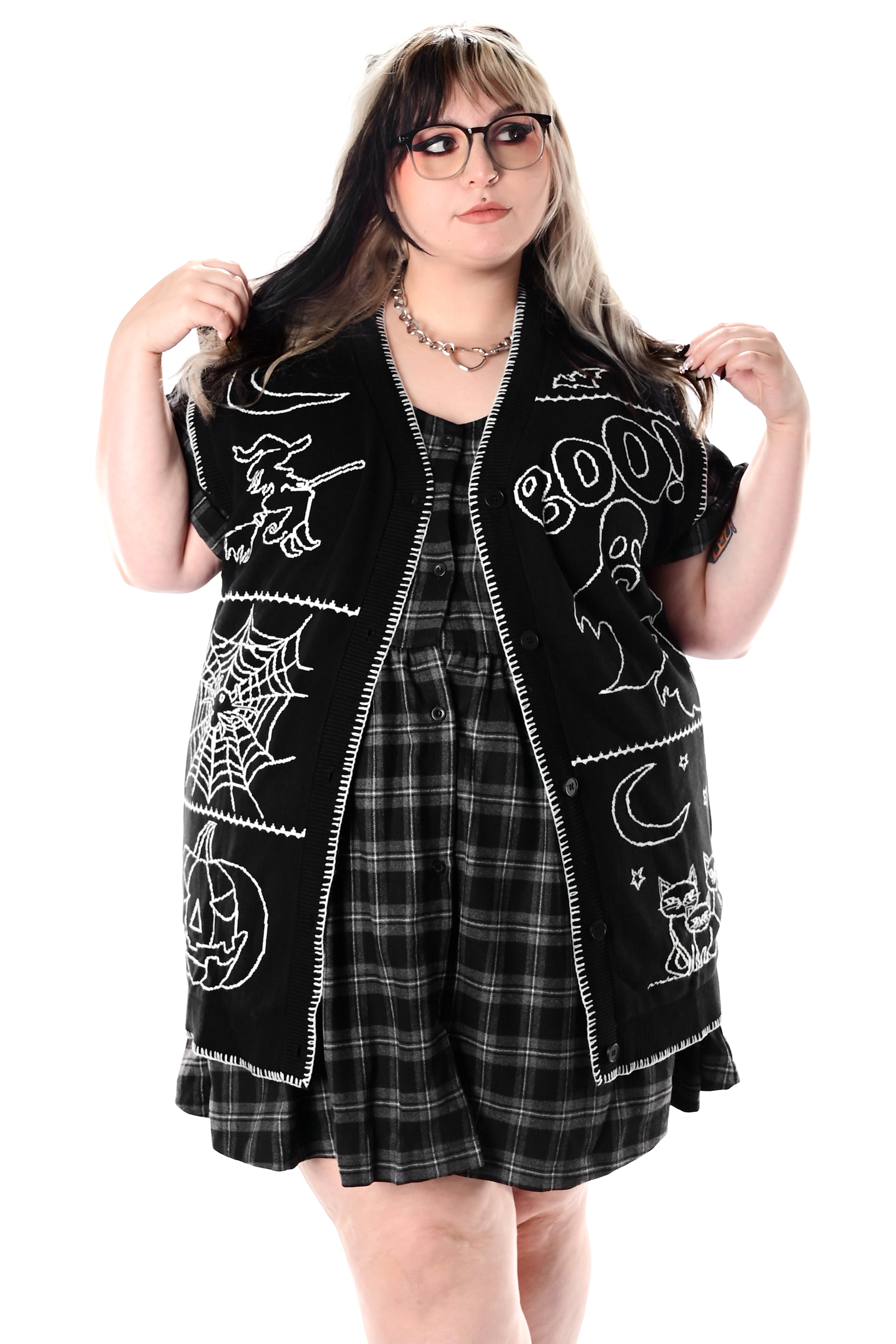 black button up sweater vest with halloween patchwork pattern and white stitching