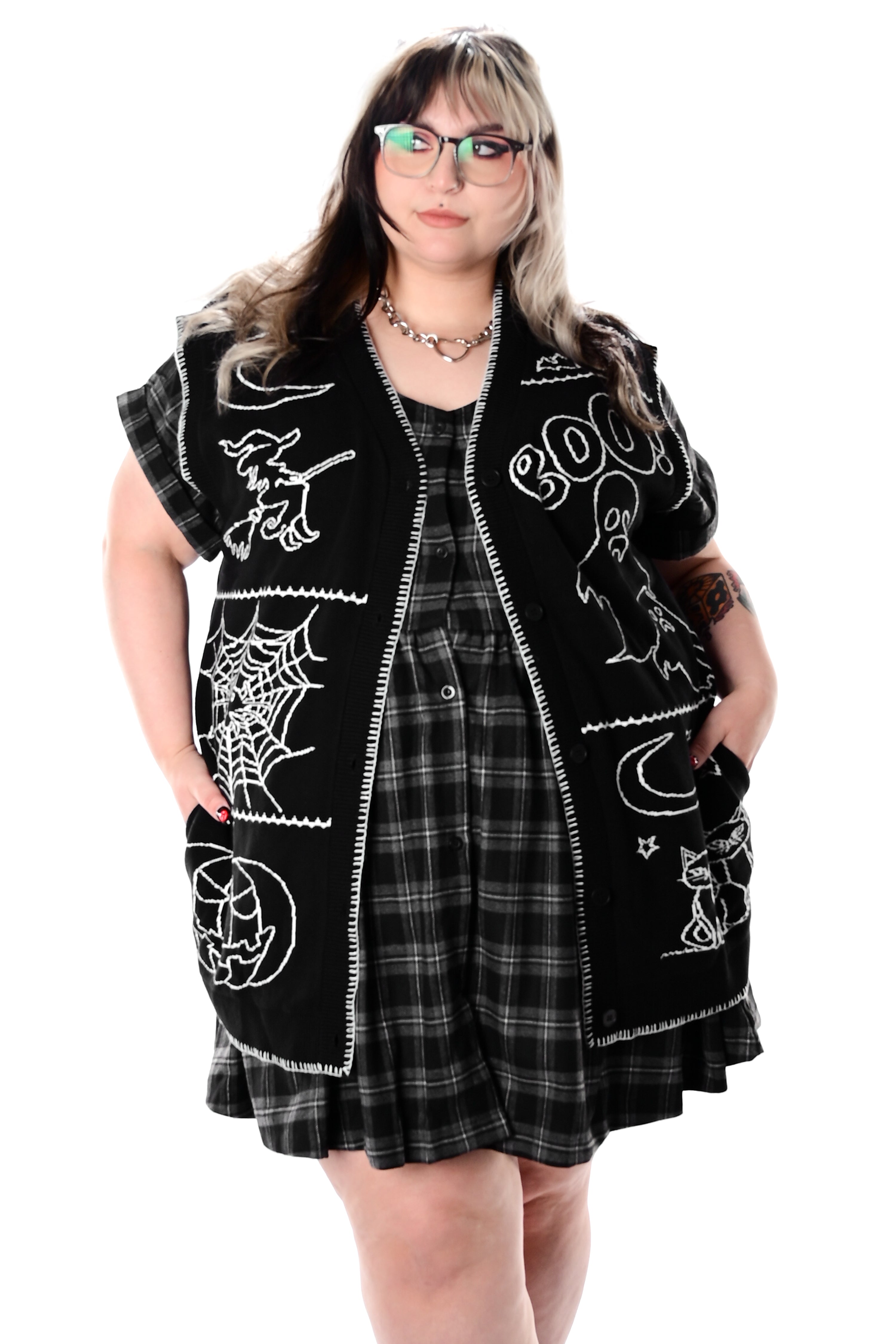 black button up sweater vest with halloween patchwork pattern and white stitching
