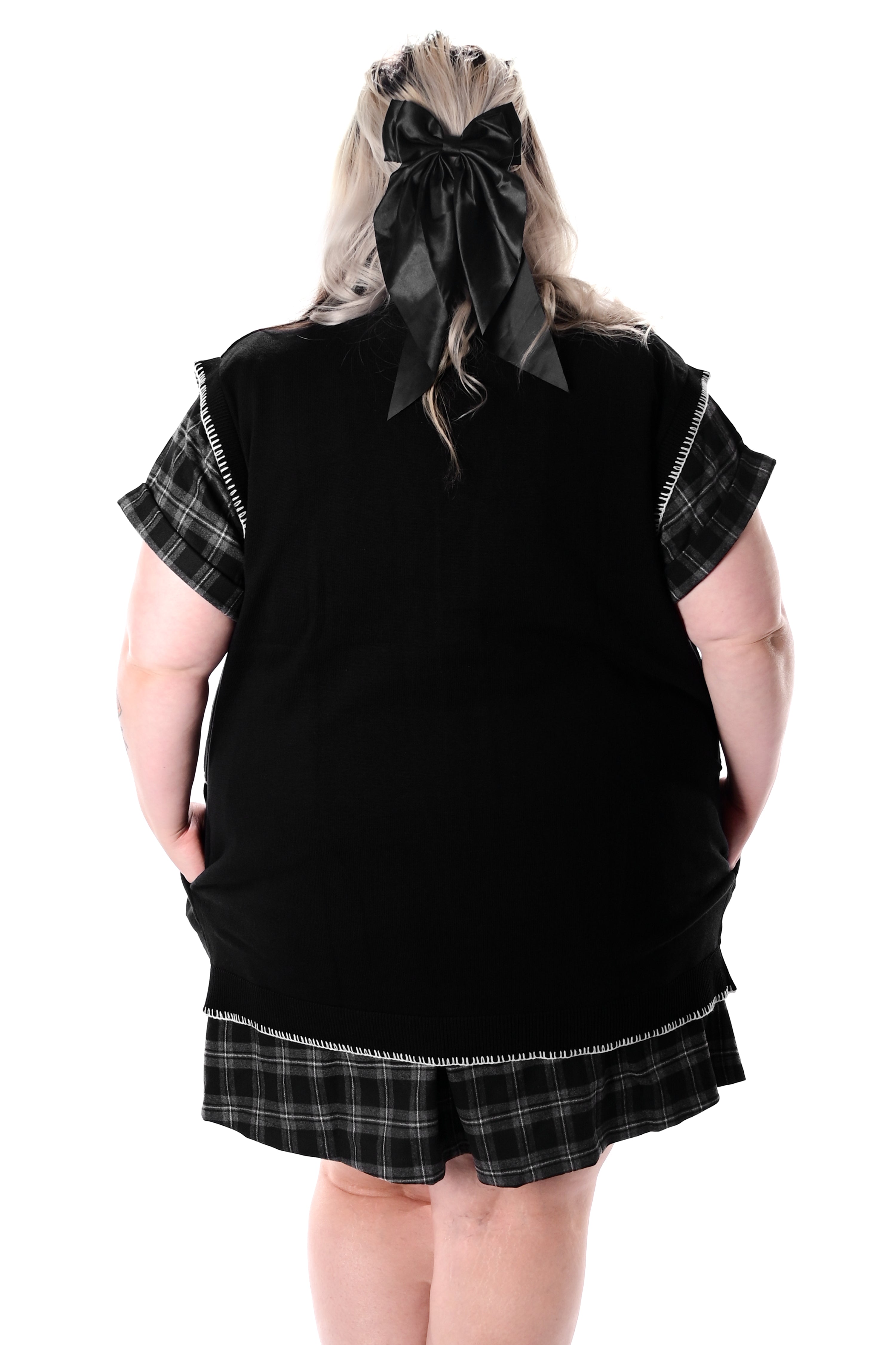 black button up sweater vest with halloween patchwork pattern and white stitching