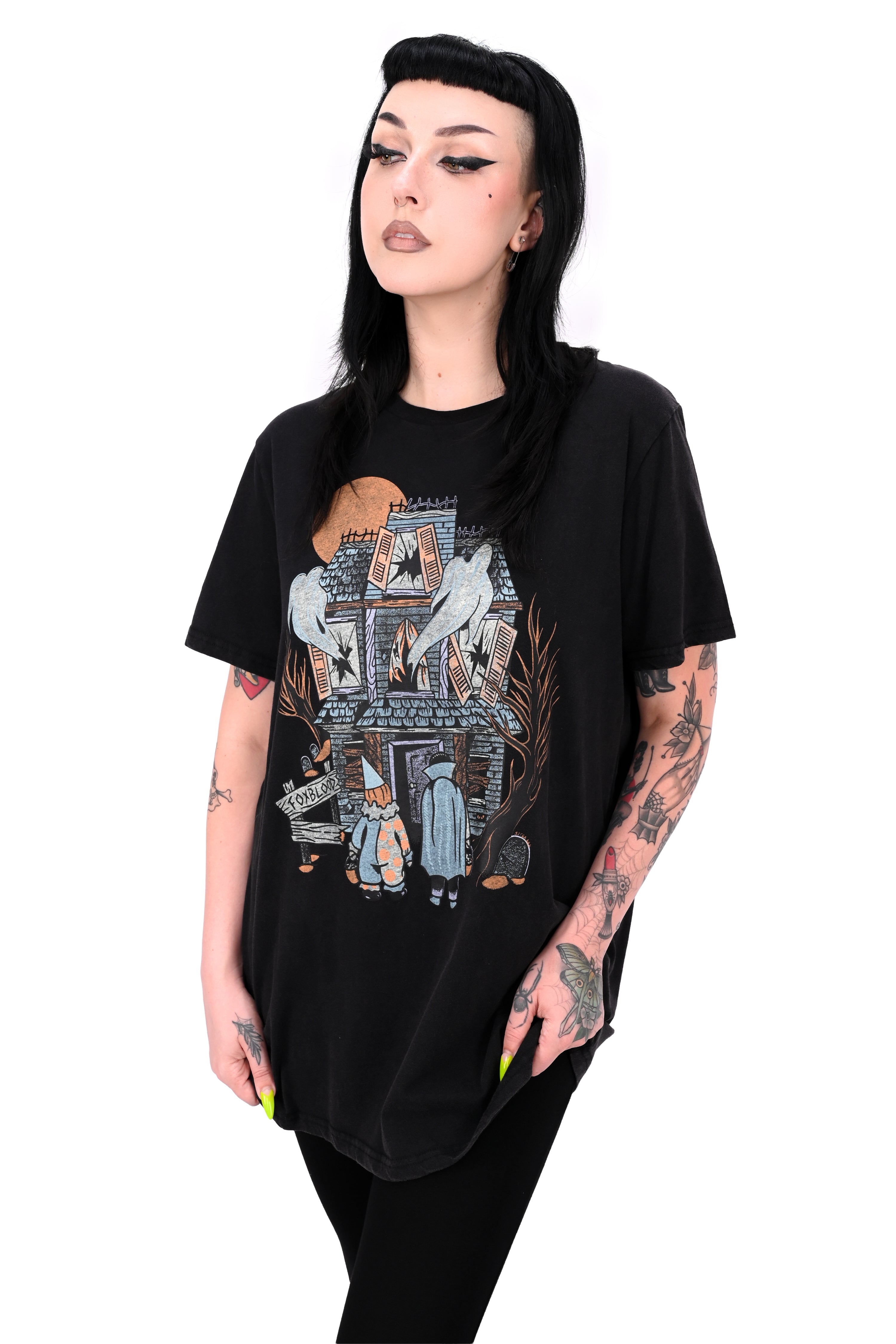 vintage black tee feature a haunted house with ghosts and two trick or treaters