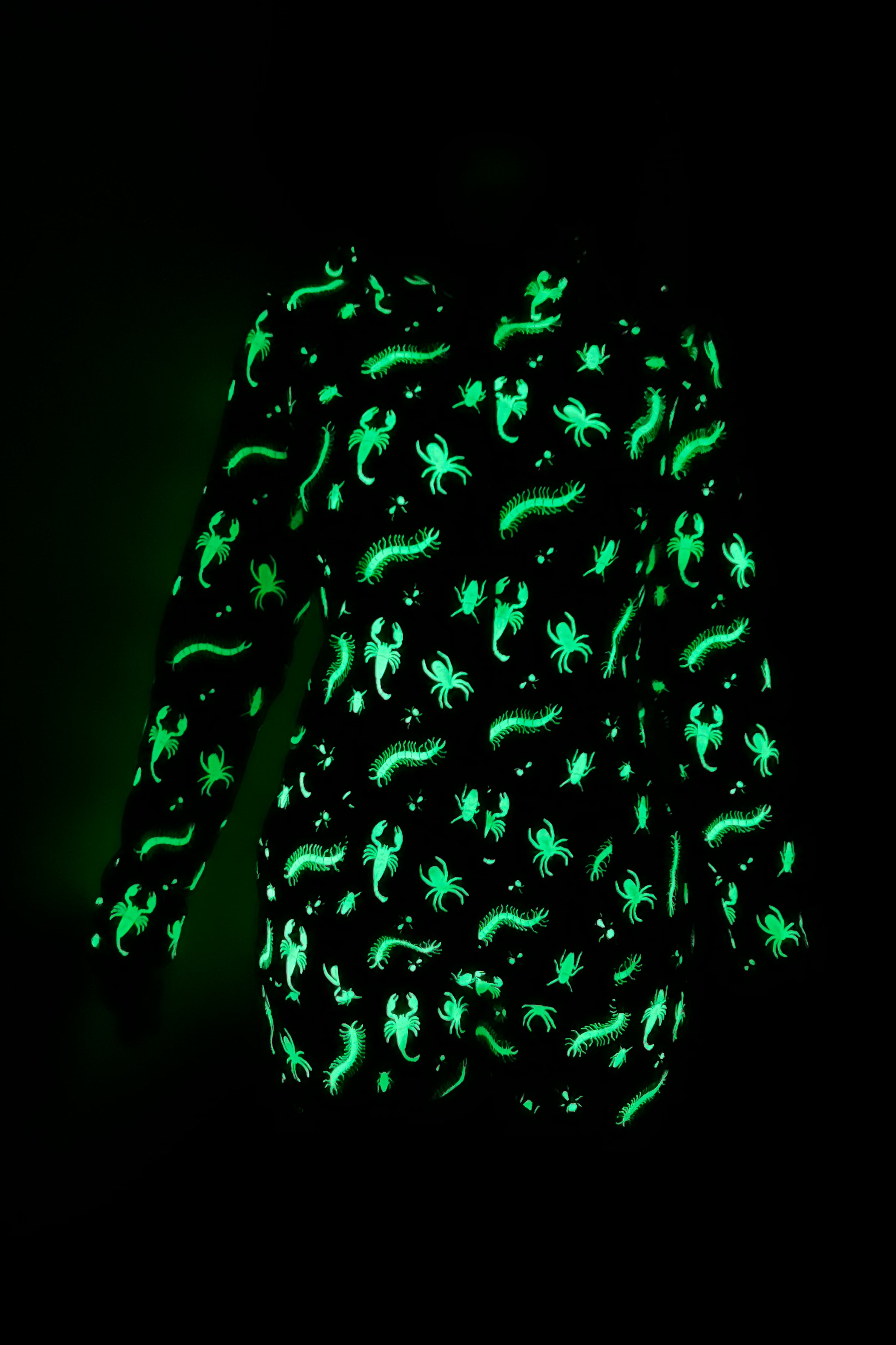 black long sleeve roper with green glow in the dark bugs print, zip up front and a hood