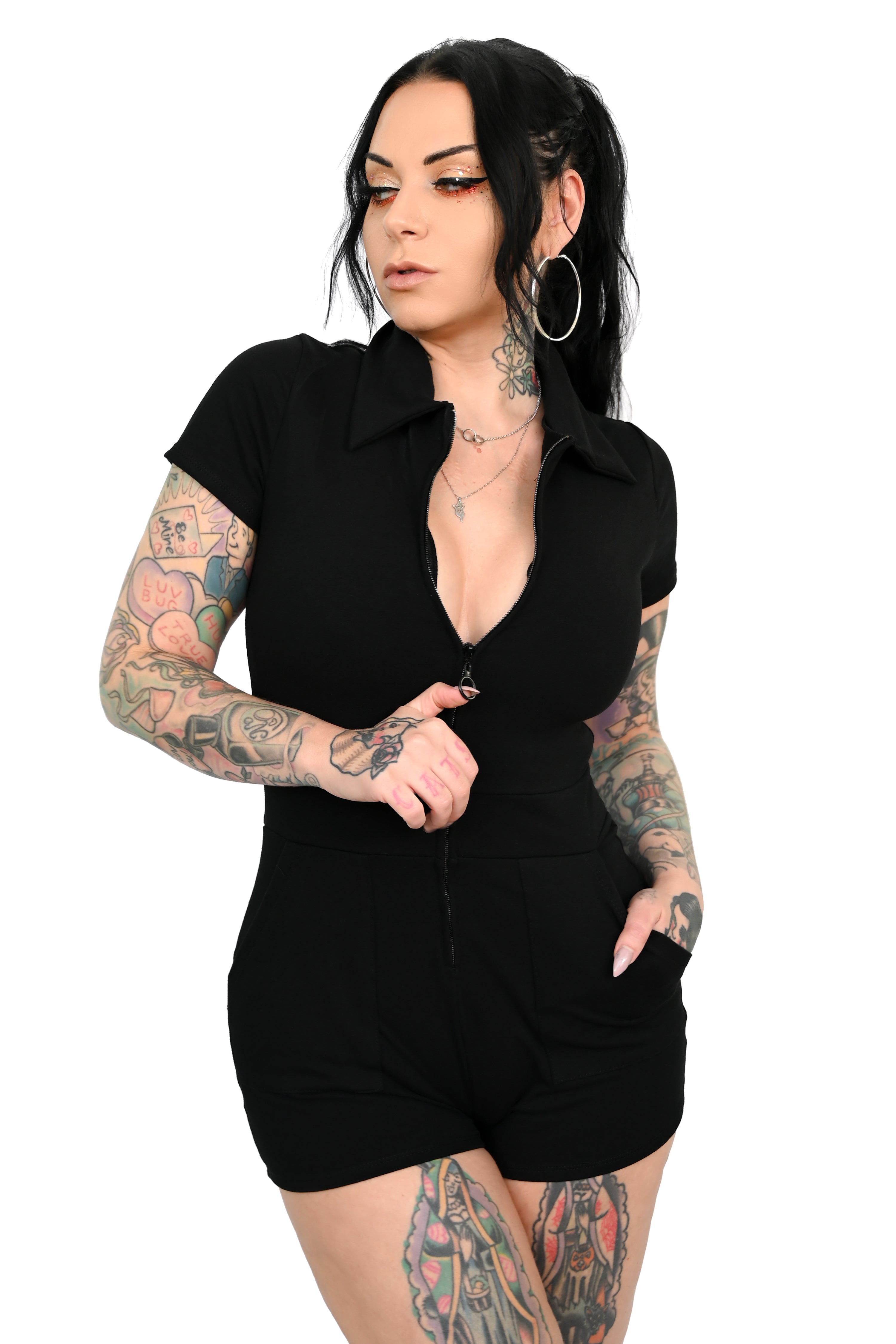 Zip up romper with deep front pockets and pointed collar.
